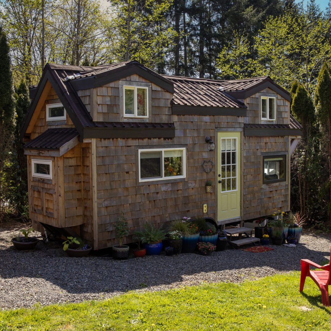 Cute little tiny home with wood paneling and privacy for a minim